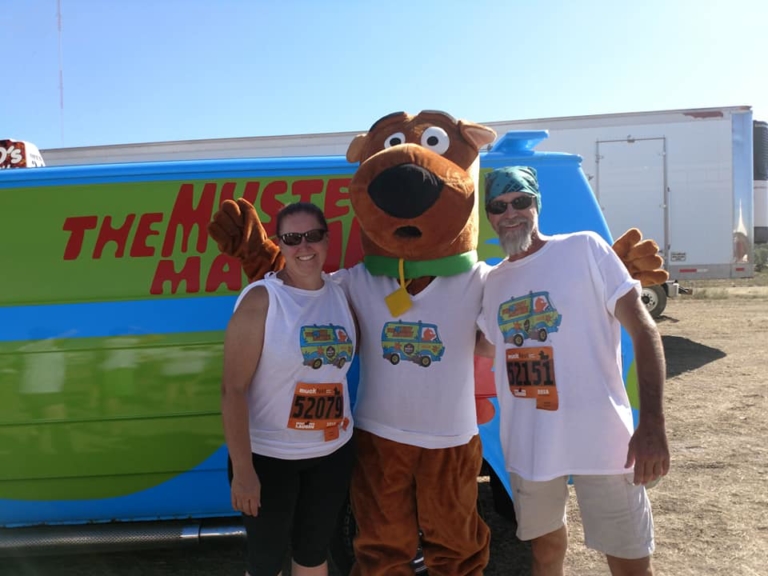 Volunteers in matching shirts promoting MSterious Miracles at an outdoor event