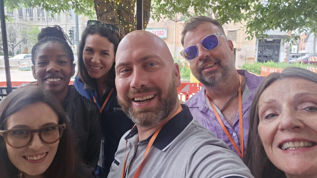 Group of MSterious Miracles volunteers wearing event lanyards